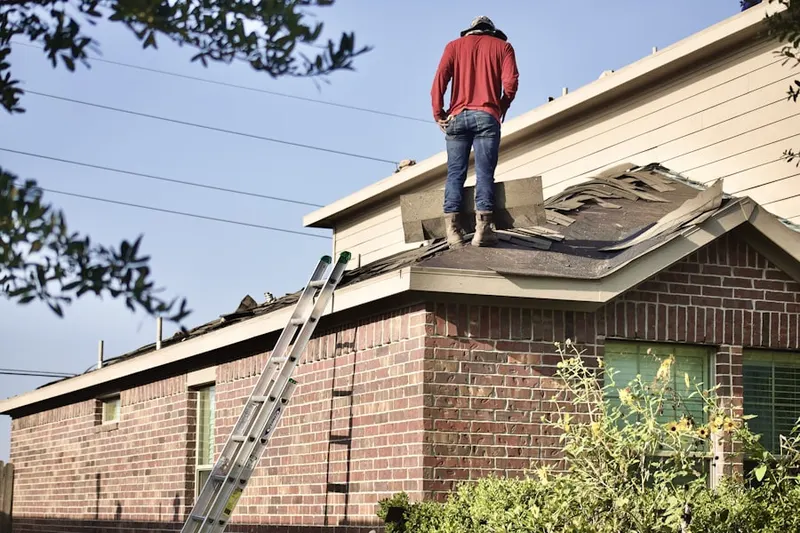 Professional roofer working on a residential roof in South Hominy